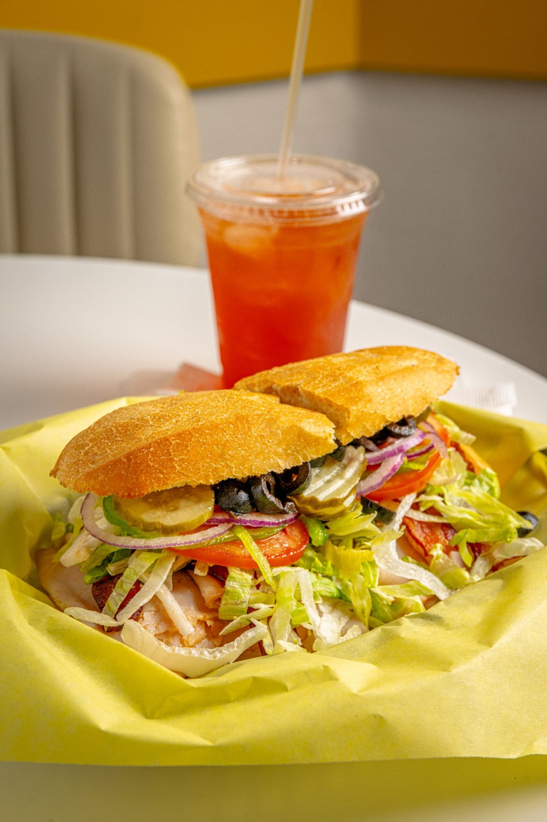 A filled sandwich served with an iced drink at Café Bliss