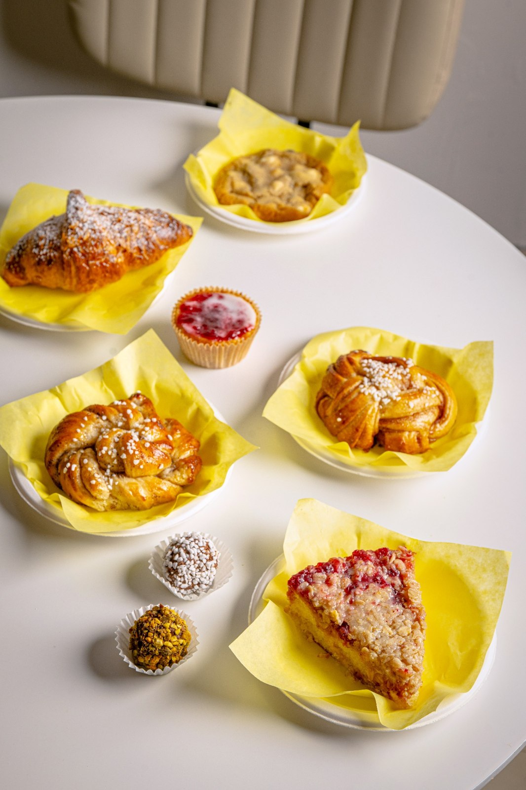 A selection of Swedish pastries and sweet treats on yellow plates